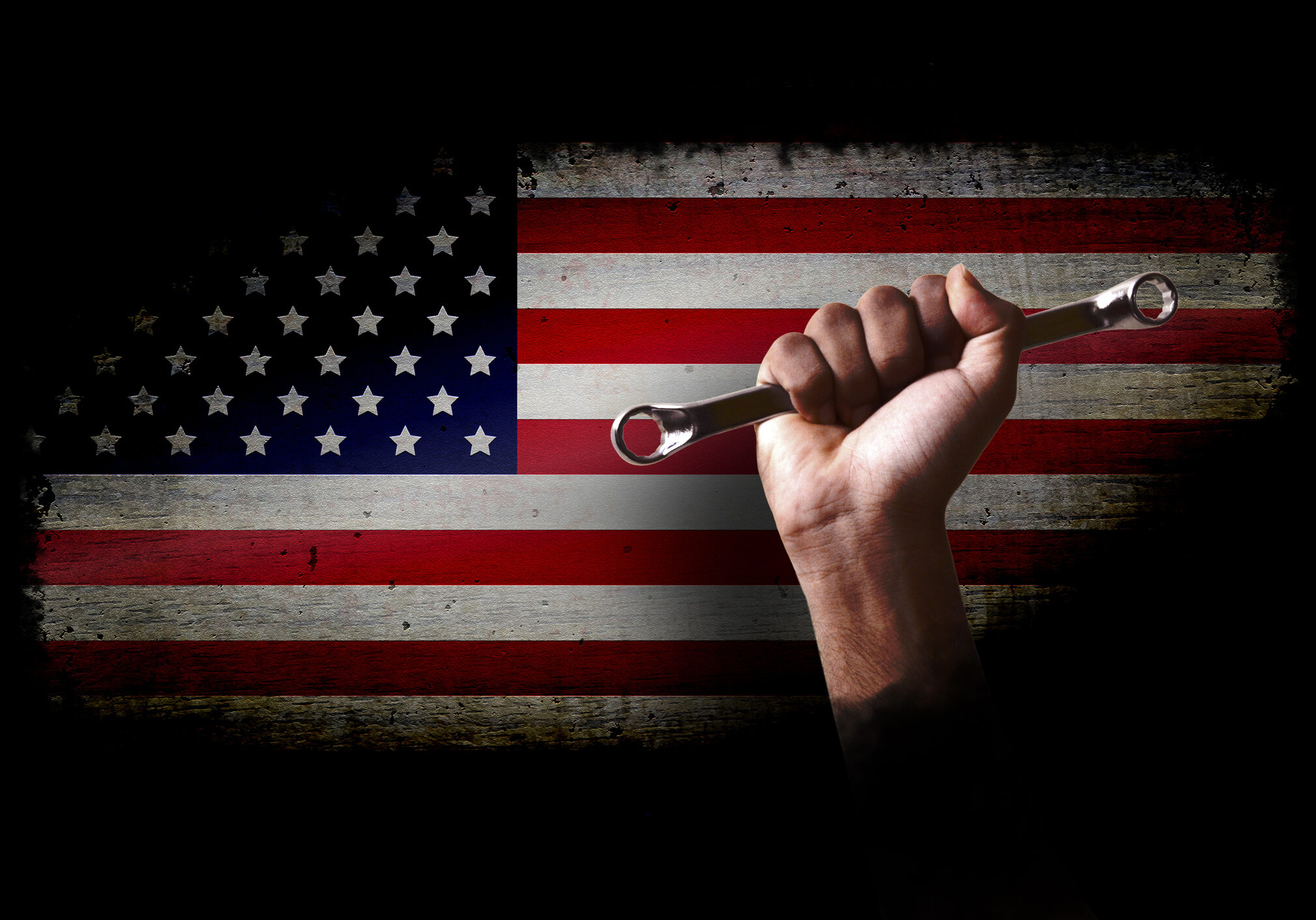 USA flag over wooden texture vignette with a strong hand holding work tool. Apt for use as posters, backdrops, banners, greeting cards for US Labor day.